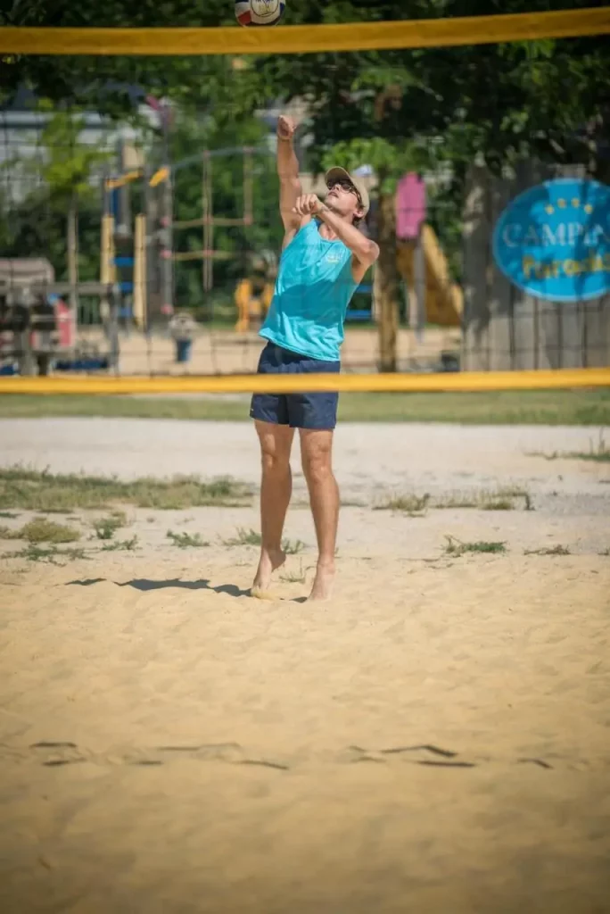 Volleyball player on a sandy court.