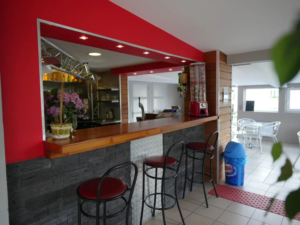 Modern bar interior with stools and counter.