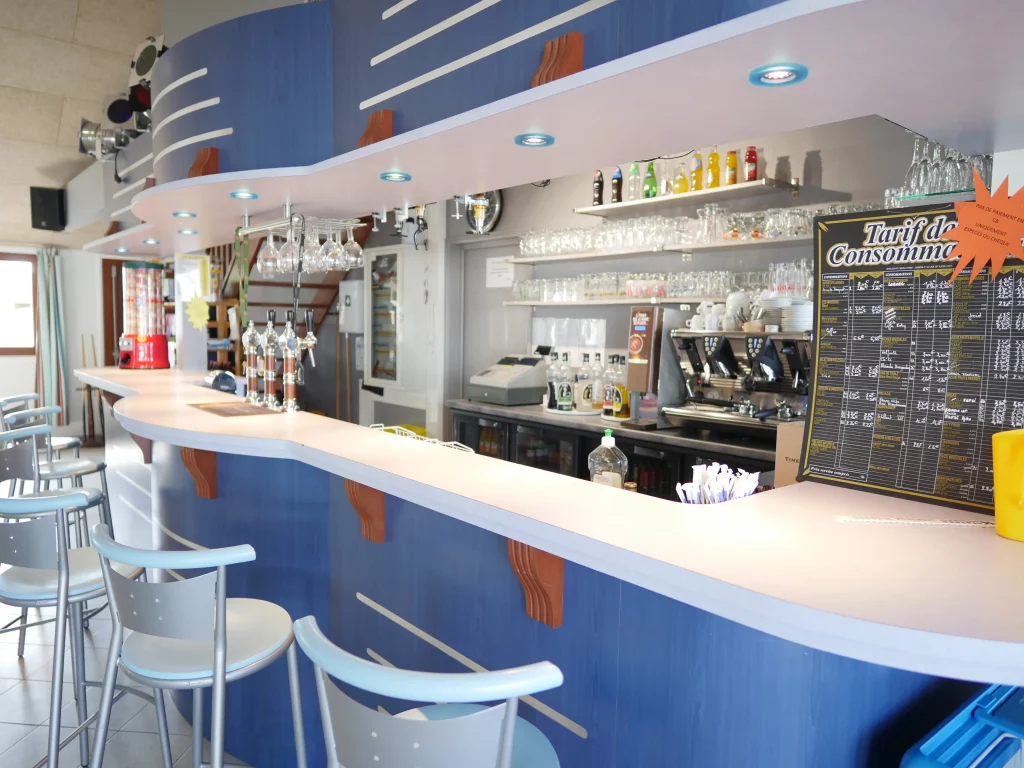 Interior of a bar with counter and stools.