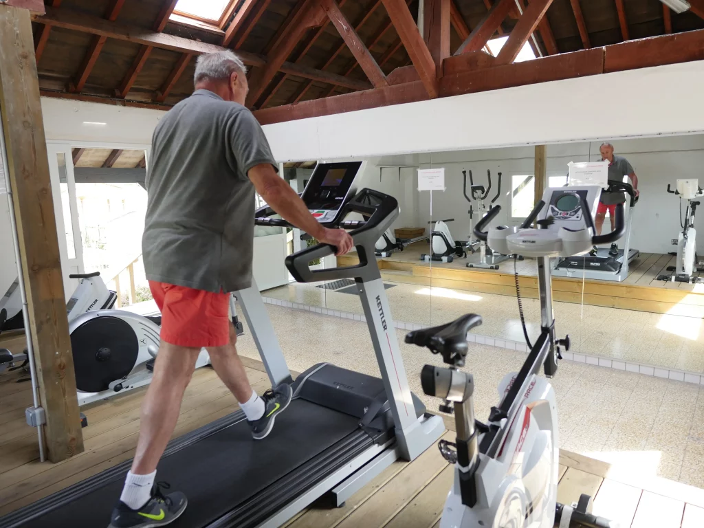 Man on a treadmill in a hall.